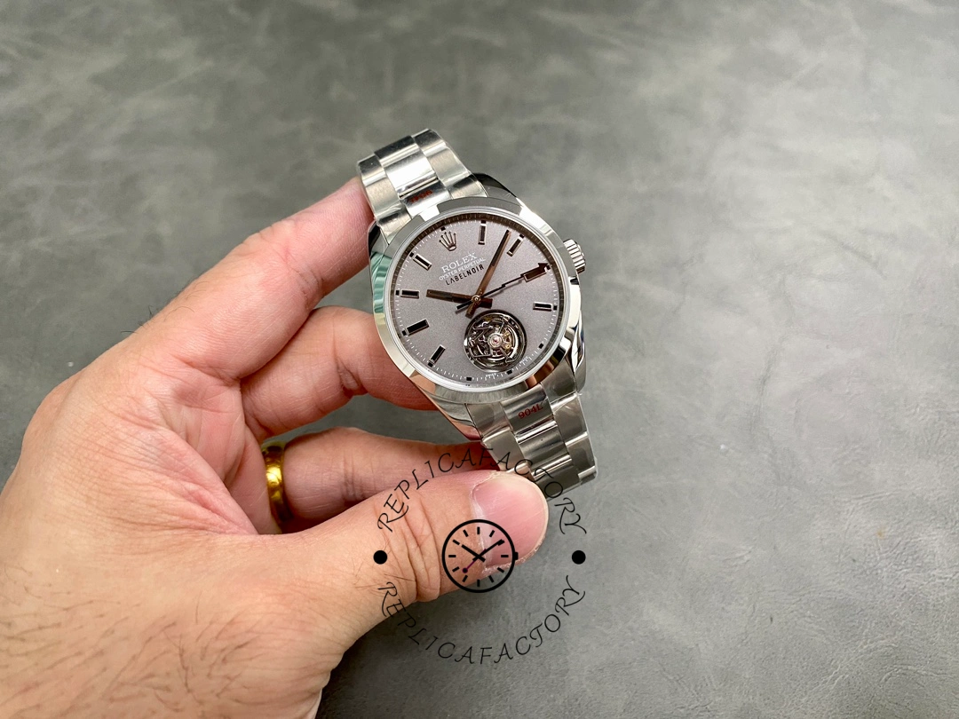 Rolex Milgauss 116400 LNT01HS-001, full watch shown in hand, stainless steel bracelet.