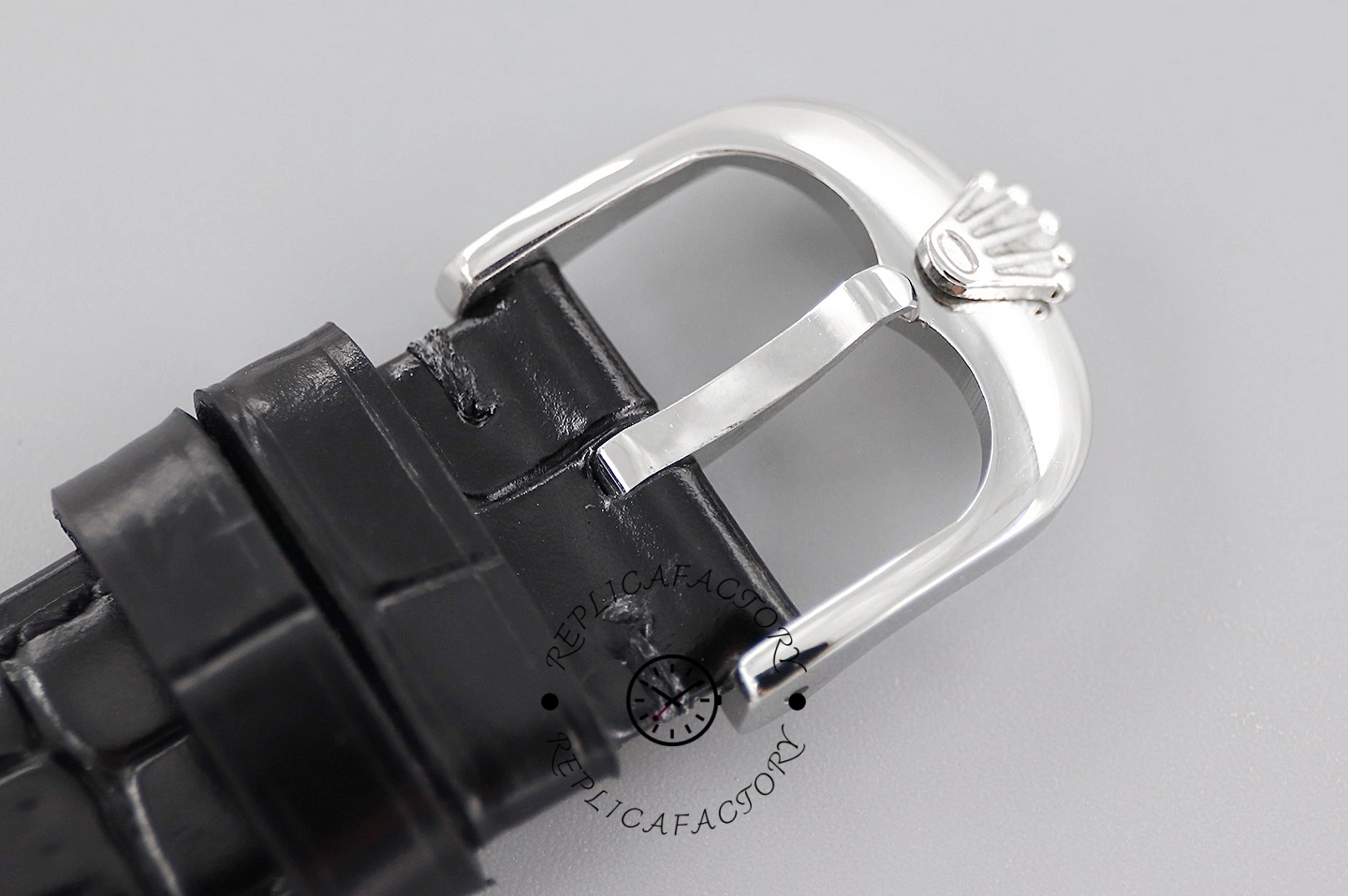 Rolex Cellini Date 50519 buckle close-up on gray, blue leather strap and tang buckle detail.