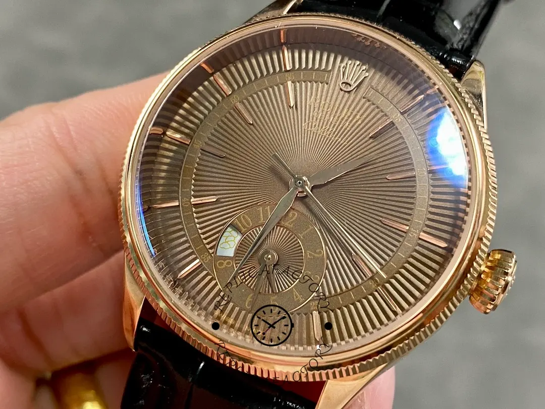 Rolex Cellini Dual Time 50525 macro dial, brown guilloché texture and hands, black leather strap.