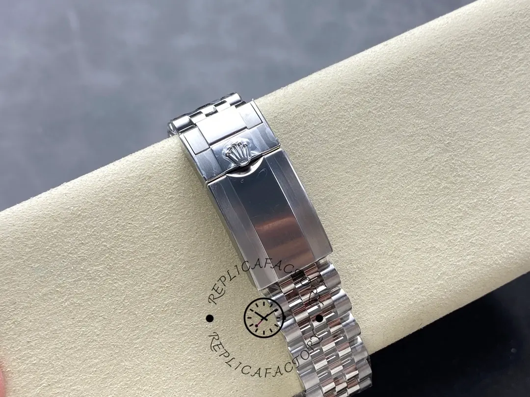 Rolex GMT-Master II M126710GRNR 0003, Jubilee bracelet clasp close-up on cushion.