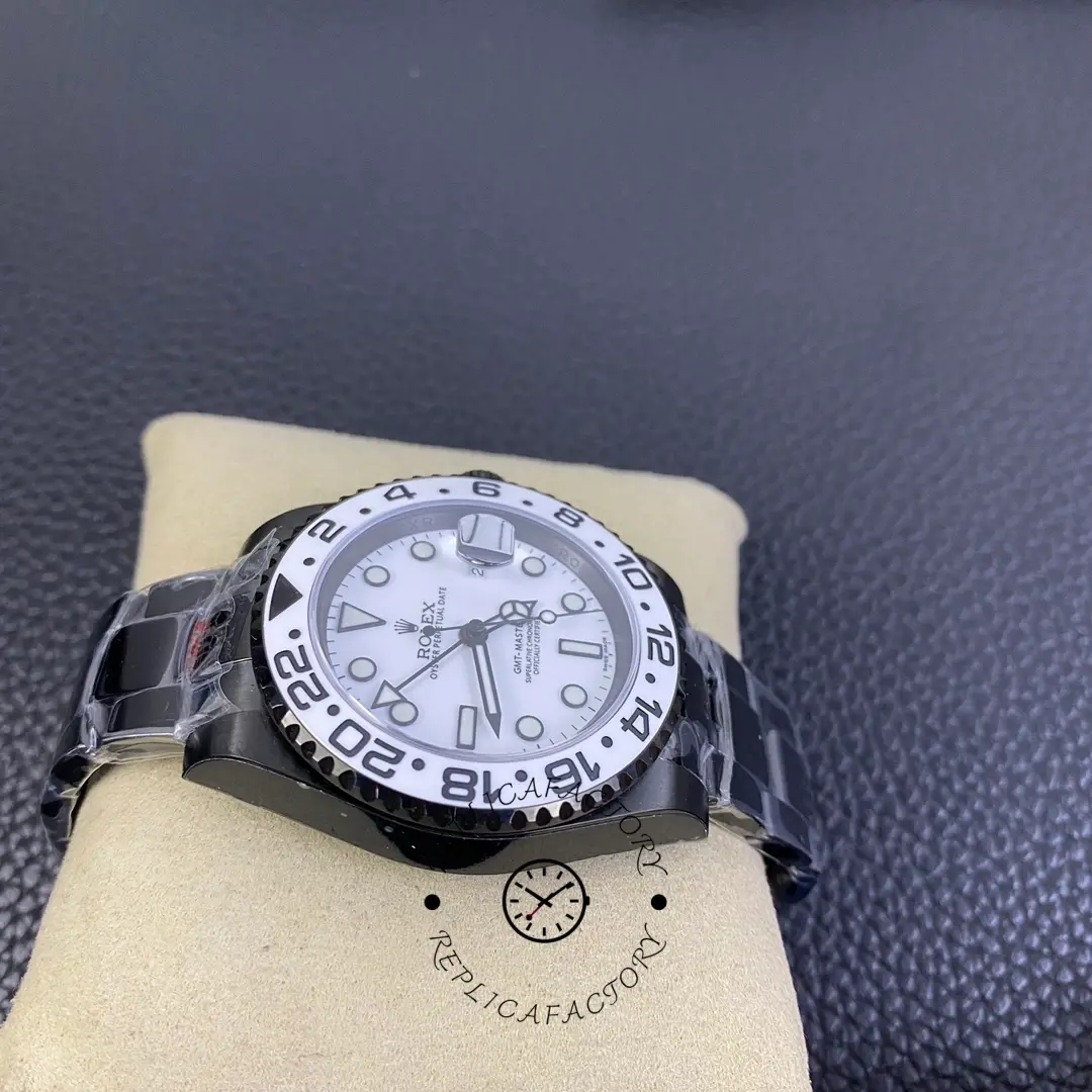 Rolex GMT-Master II 16710 side view, black PVD/DLC case profile and bezel edge, on cushion.