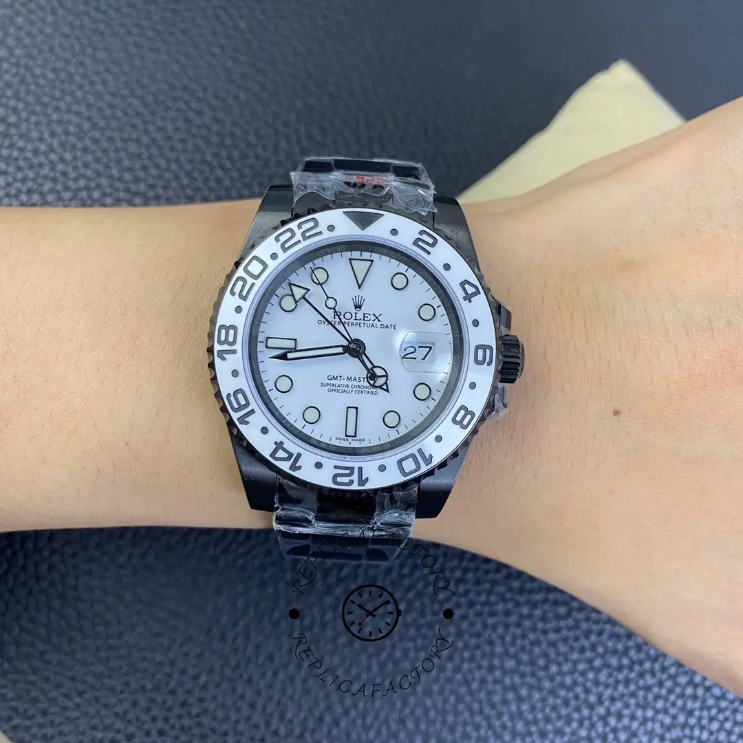 Rolex GMT-Master II 16710 on wrist, white dial and black bezel, black PVD/DLC bracelet, front view.