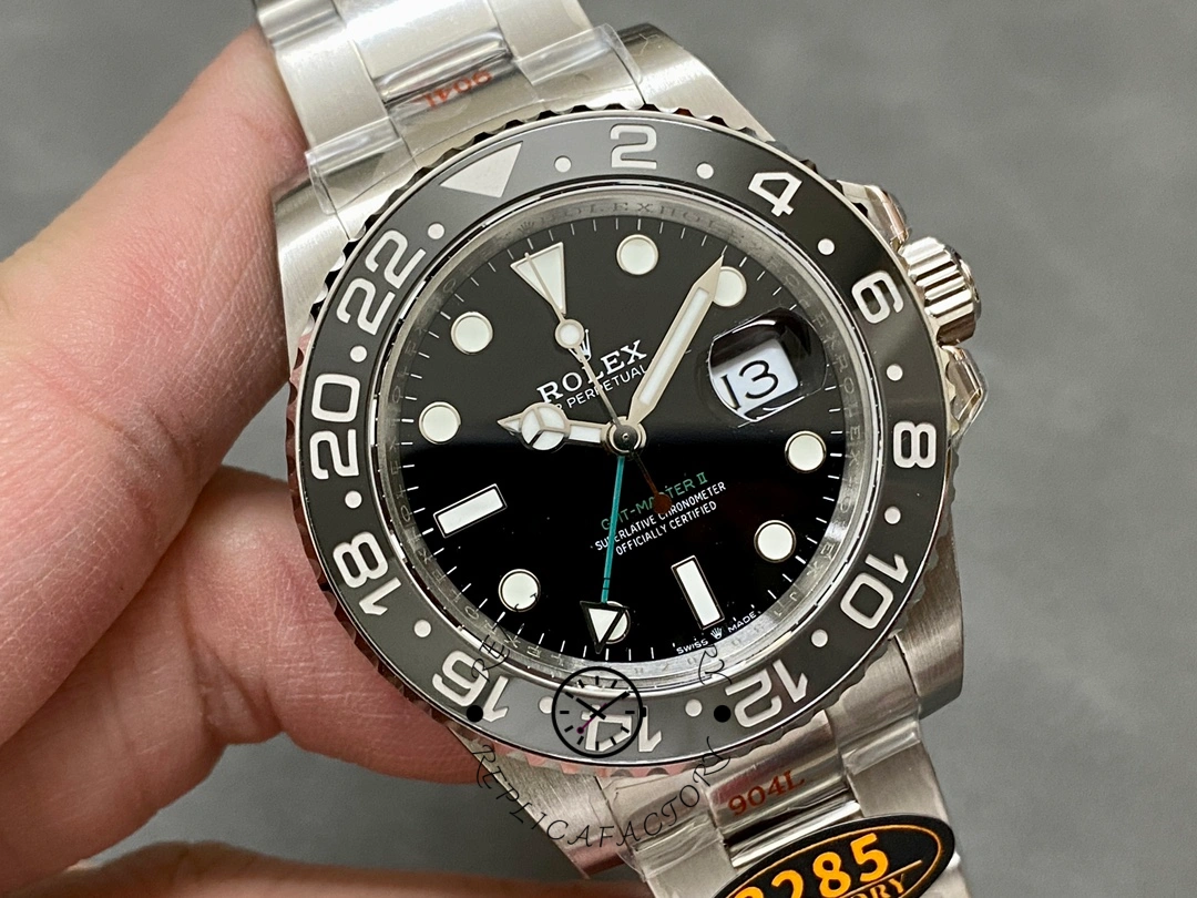Handheld close-up of Rolex GMT-Master II 116710LN, dial, bezel numbers, and cyclops date.