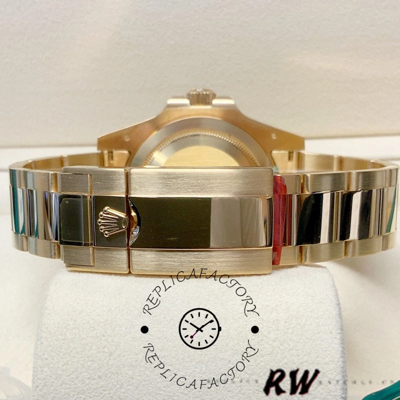 Rolex GMT-Master II m126718grnr 0001, side profile showing gold bracelet and clasp on stand.