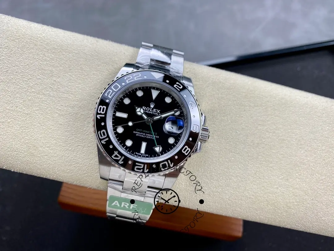 Rolex GMT-Master II 116710LN, full watch on cushion showing steel bracelet fit.