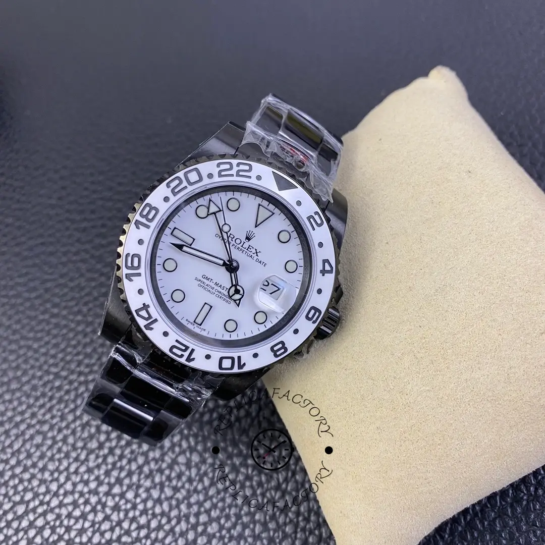 Rolex GMT-Master II 16710 front angle on cushion, white dial markers and hands, black coated bracelet.