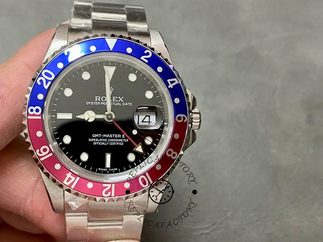 Rolex GMT-Master II 16710, hand-held front view showing Pepsi bezel and steel bracelet.