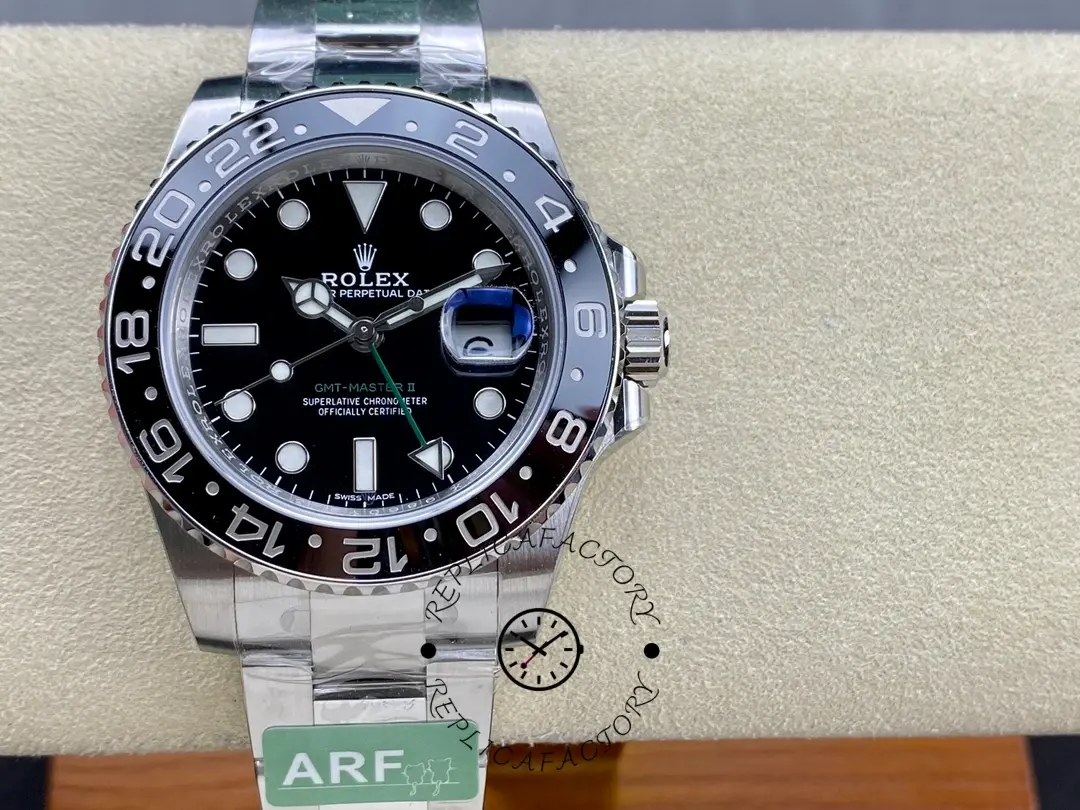 Rolex GMT-Master II 116710LN, front view on cushion showing black dial and bezel.