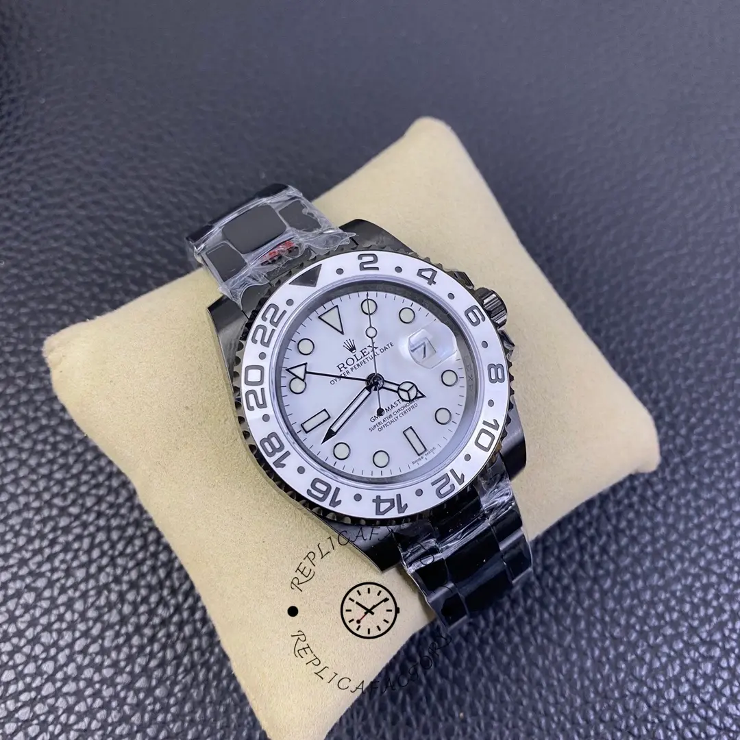 Rolex GMT-Master II 16710 angled view on cushion, white dial, black bezel, black PVD/DLC bracelet.