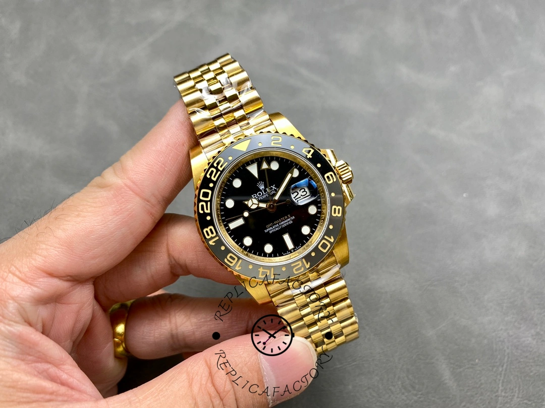 Rolex GMT-Master II m126718grnr 0001, hand-held full watch showing gold bracelet and bezel.