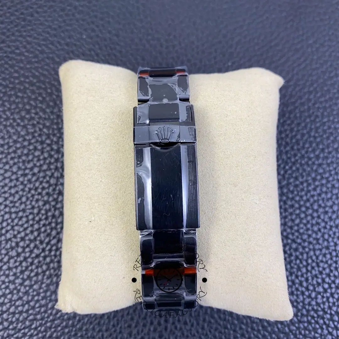 Rolex GMT-Master II 16710 clasp view, black coated clasp and links, on cushion.