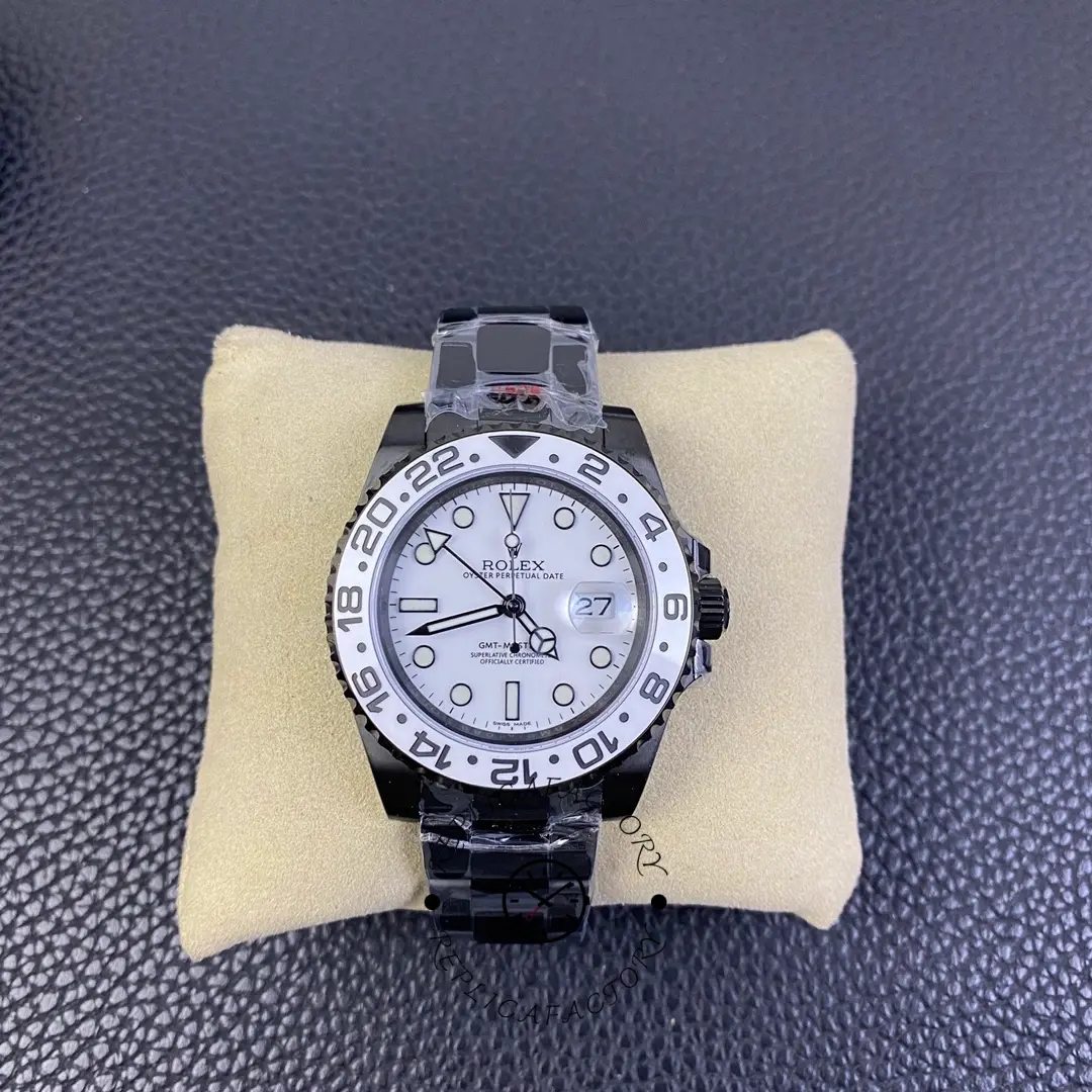 Rolex GMT-Master II 16710 on cushion, white dial and black bezel, black PVD/DLC bracelet, front view.