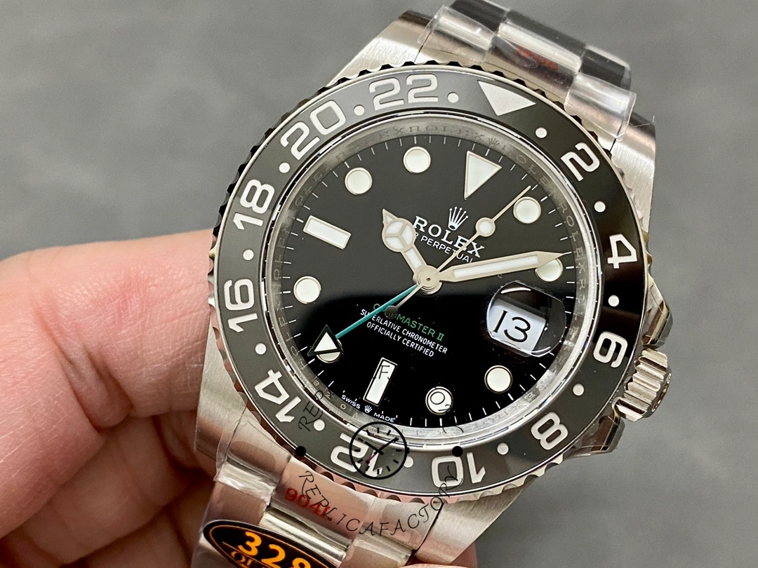 Handheld front view of Rolex GMT-Master II 116710LN, showing green GMT hand and markers.