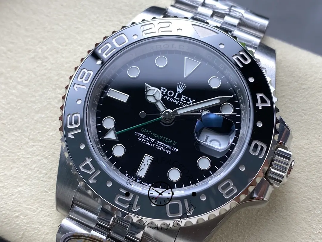 Rolex GMT-Master II M126710GRNR 0003, close-up showing bezel scale and glossy black dial.