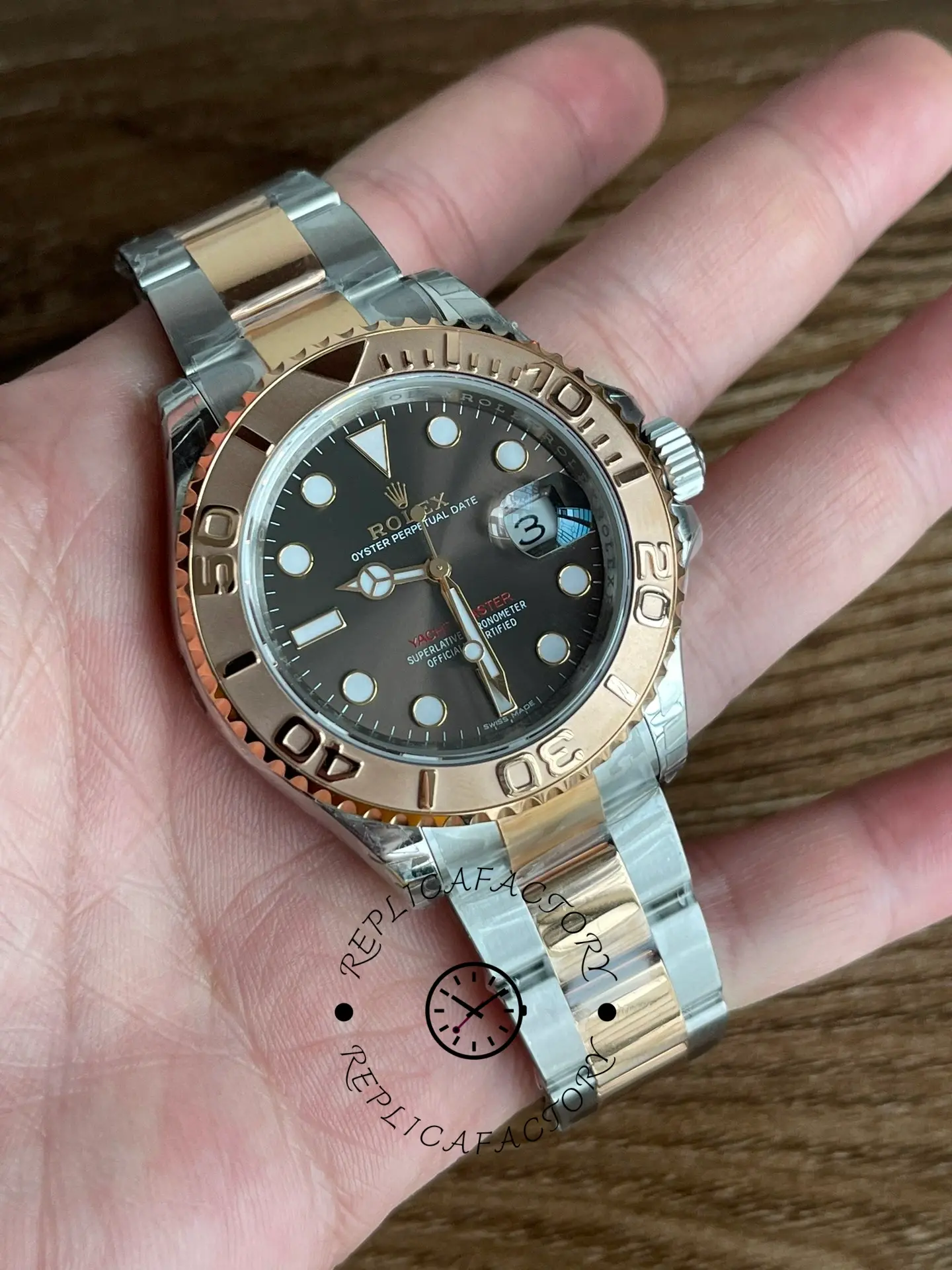 Rolex Yacht-Master 126621 held in hand, black dial and Everose bezel, rolesor bracelet, full view.
