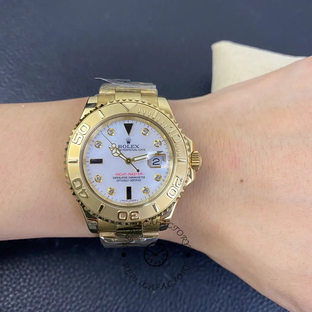 Rolex Yacht-Master 168628, wrist shot showing white MOP diamond dial, yellow gold, 35mm.