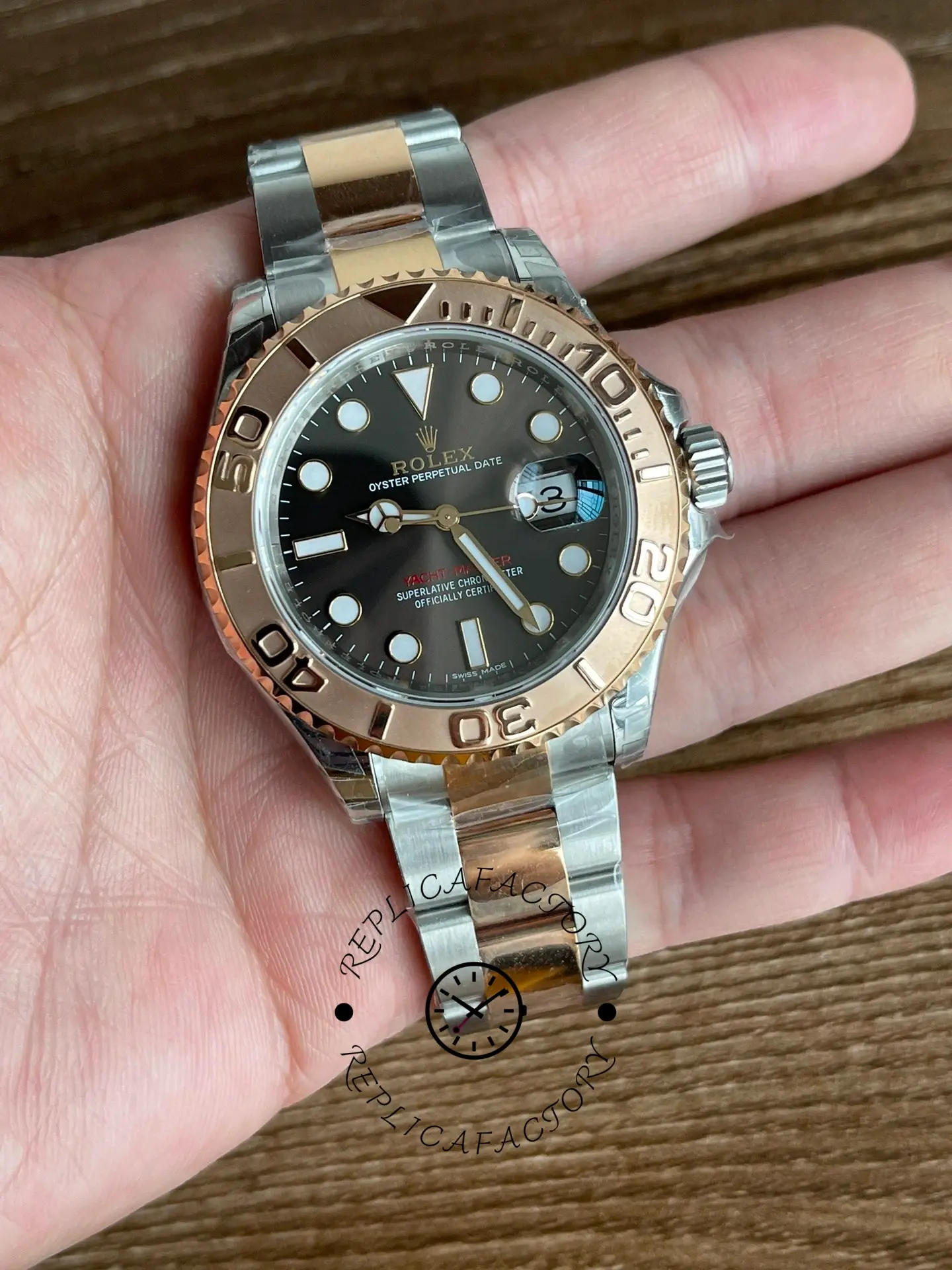 Rolex Yacht-Master 126621 held in hand, full front view, black dial, rolesor bracelet, palm shot.