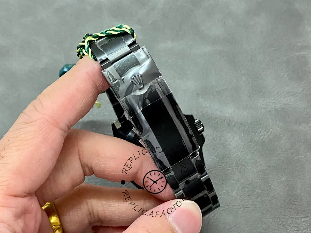 Rolex Yacht-Master 126622-0002, clasp and bracelet detail held in hand, black finish.