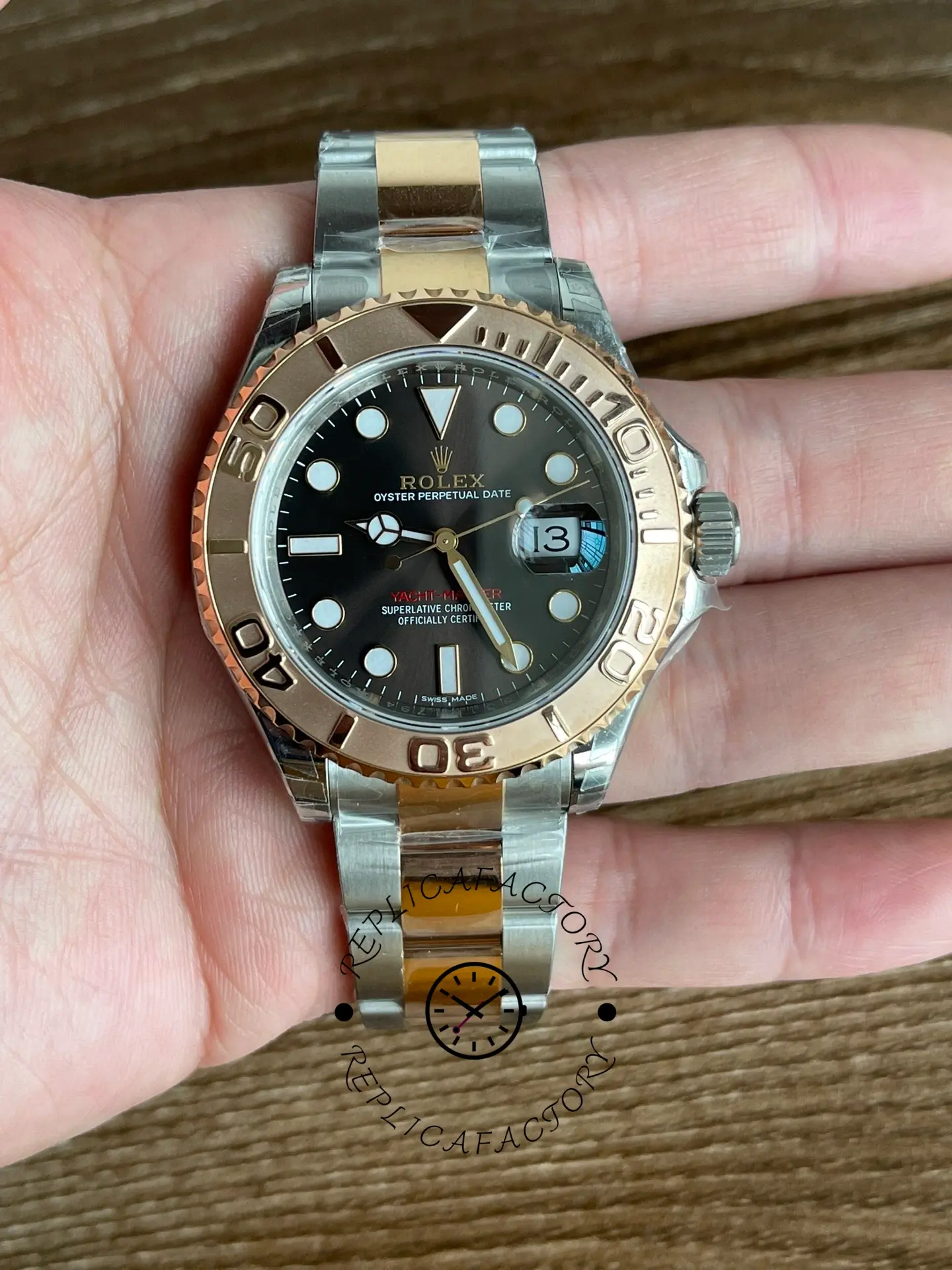 Rolex Yacht-Master 126621 held in hand, front view of black dial and bezel, rolesor bracelet.