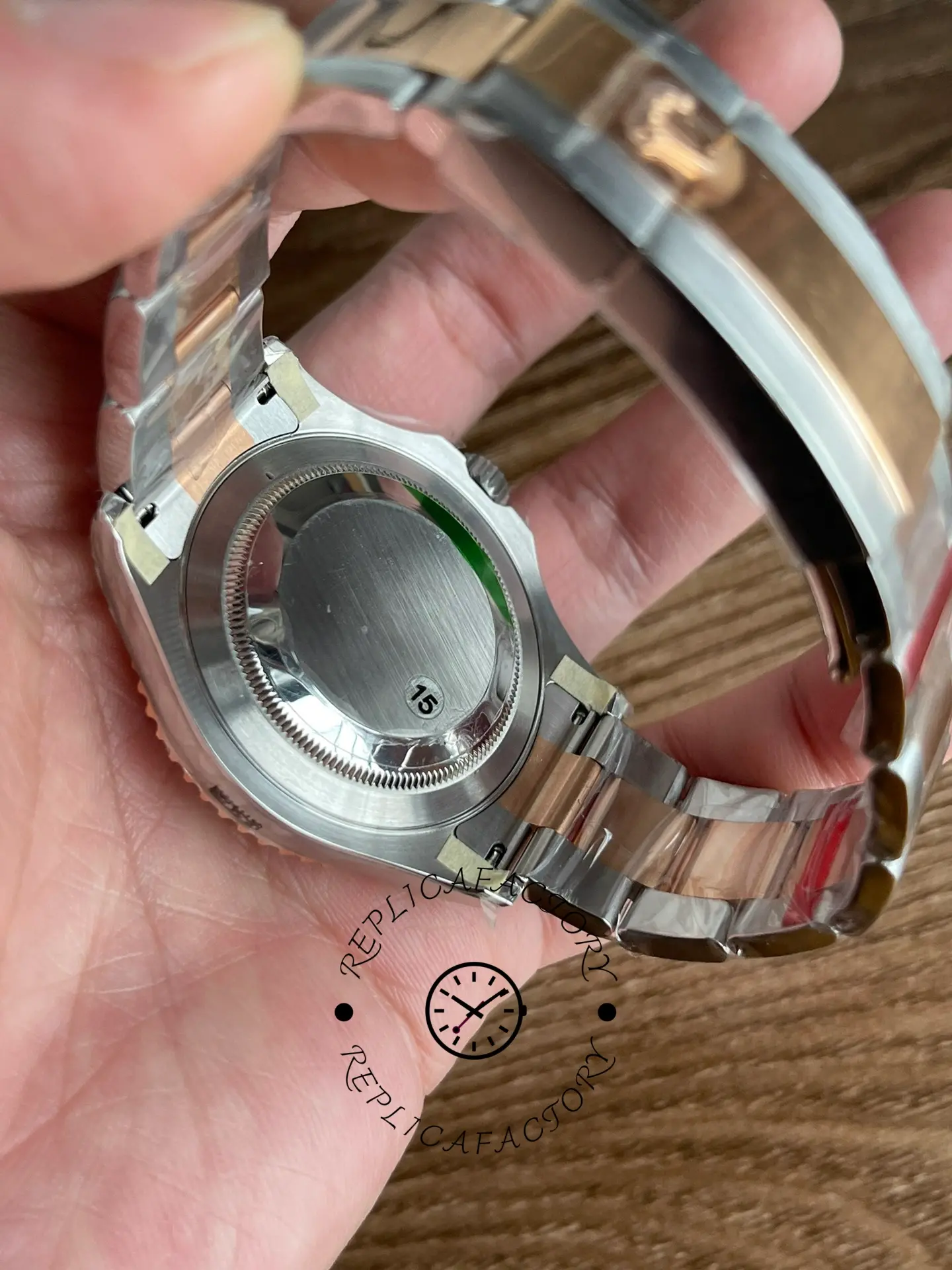 Rolex Yacht-Master 126621 case back view in hand, bracelet underside and clasp, rear angle.