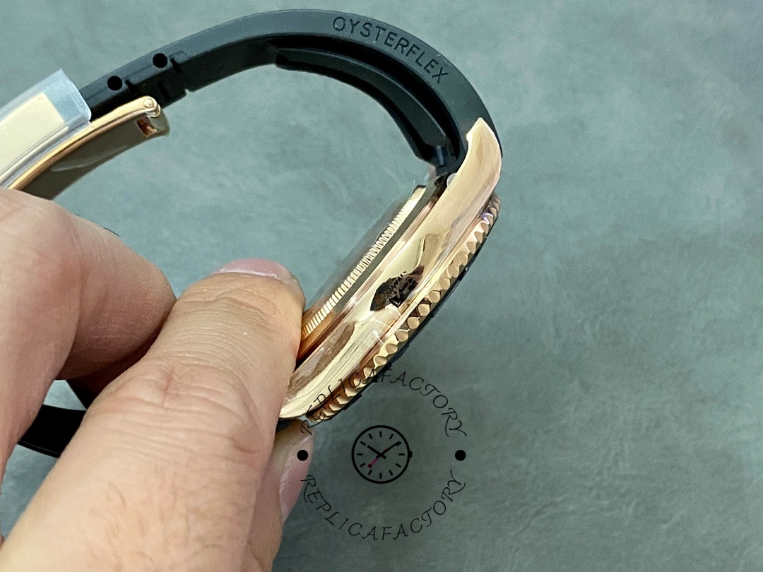 Rolex Yacht-Master 126655 side profile in hand, case thickness and bezel edge, strap visible.