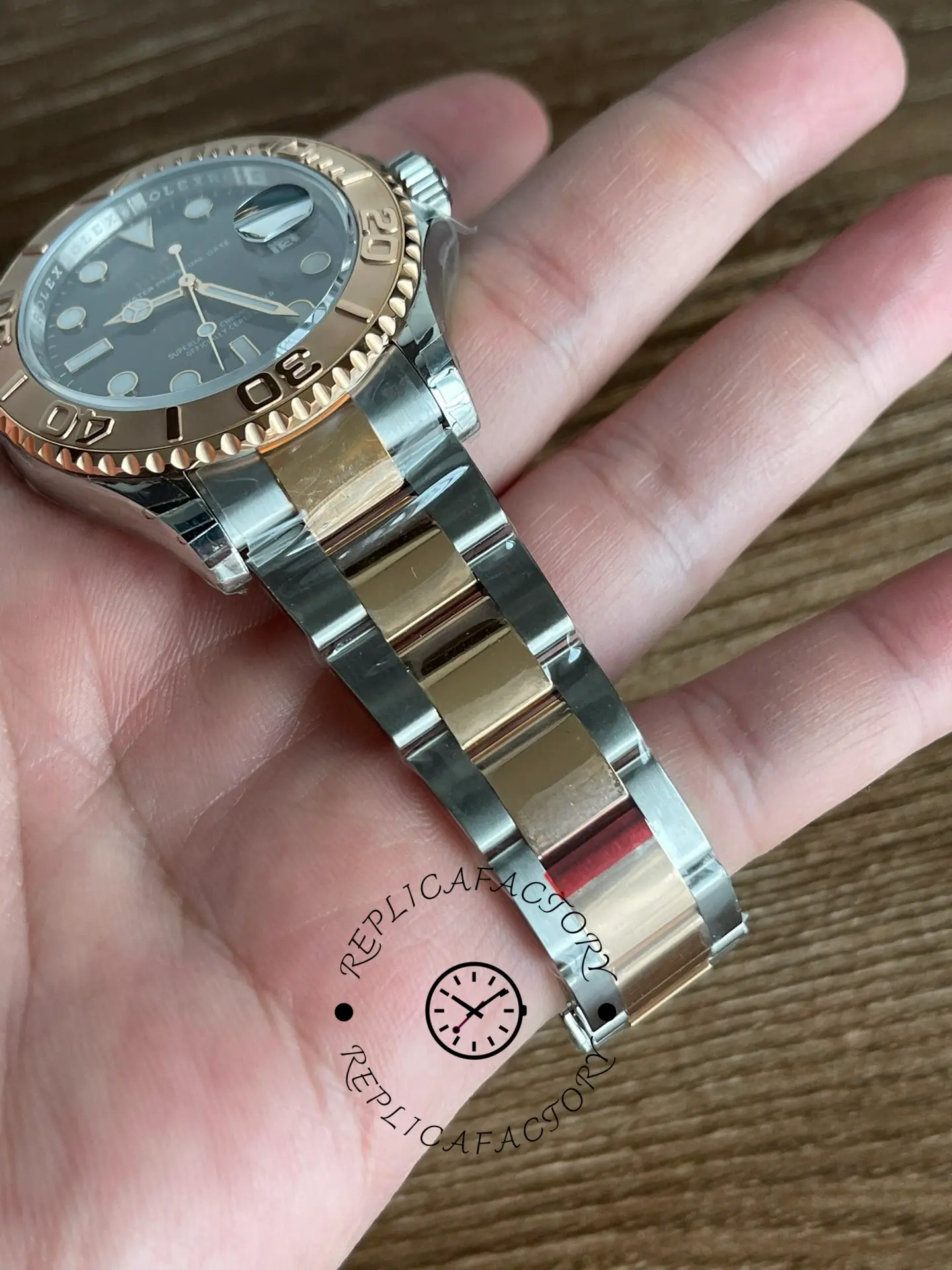 Rolex Yacht-Master 126621 bracelet close-up in hand, Everose center links and clasp detail.