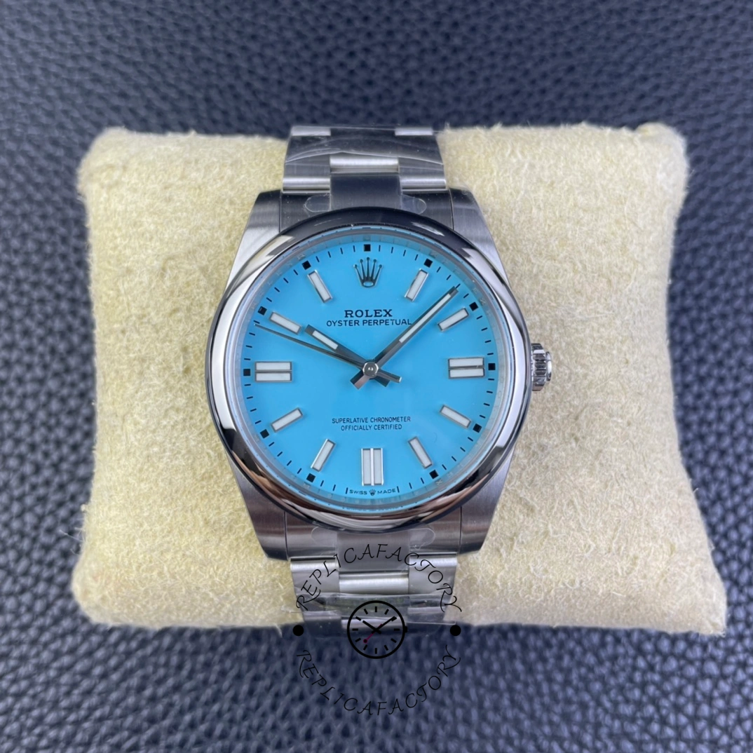 Rolex Oyster Perpetual 41 m124300 0006, top view on pillow showing turquoise dial and bracelet.
