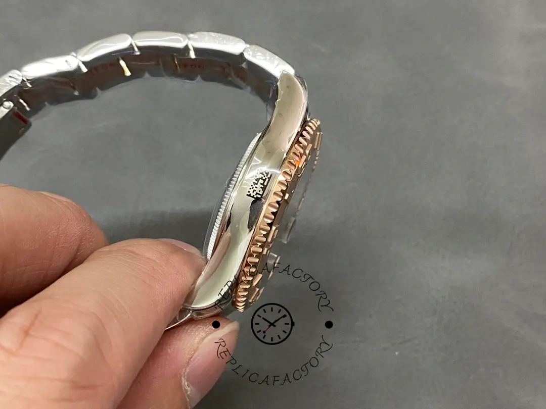 Rolex Yacht-Master 268621 side view in hand, case profile and bezel edge, bracelet shown.