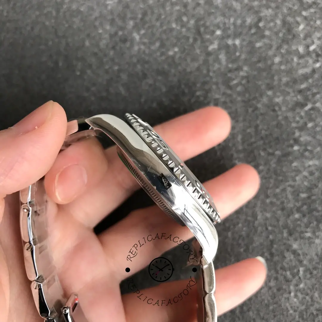 Rolex Yacht-Master 168622, side view showing bracelet curvature and clasp section in hand.