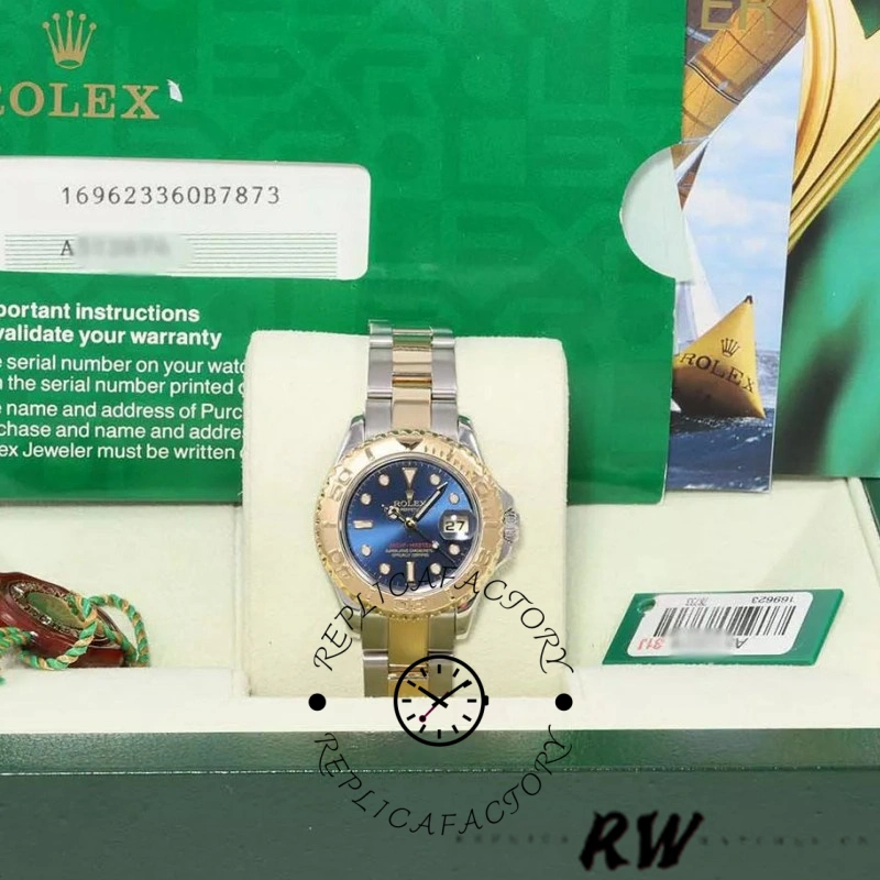 Rolex Yacht-Master 169623 in Rolex box, blue dial and gold bezel, two-tone bracelet display.