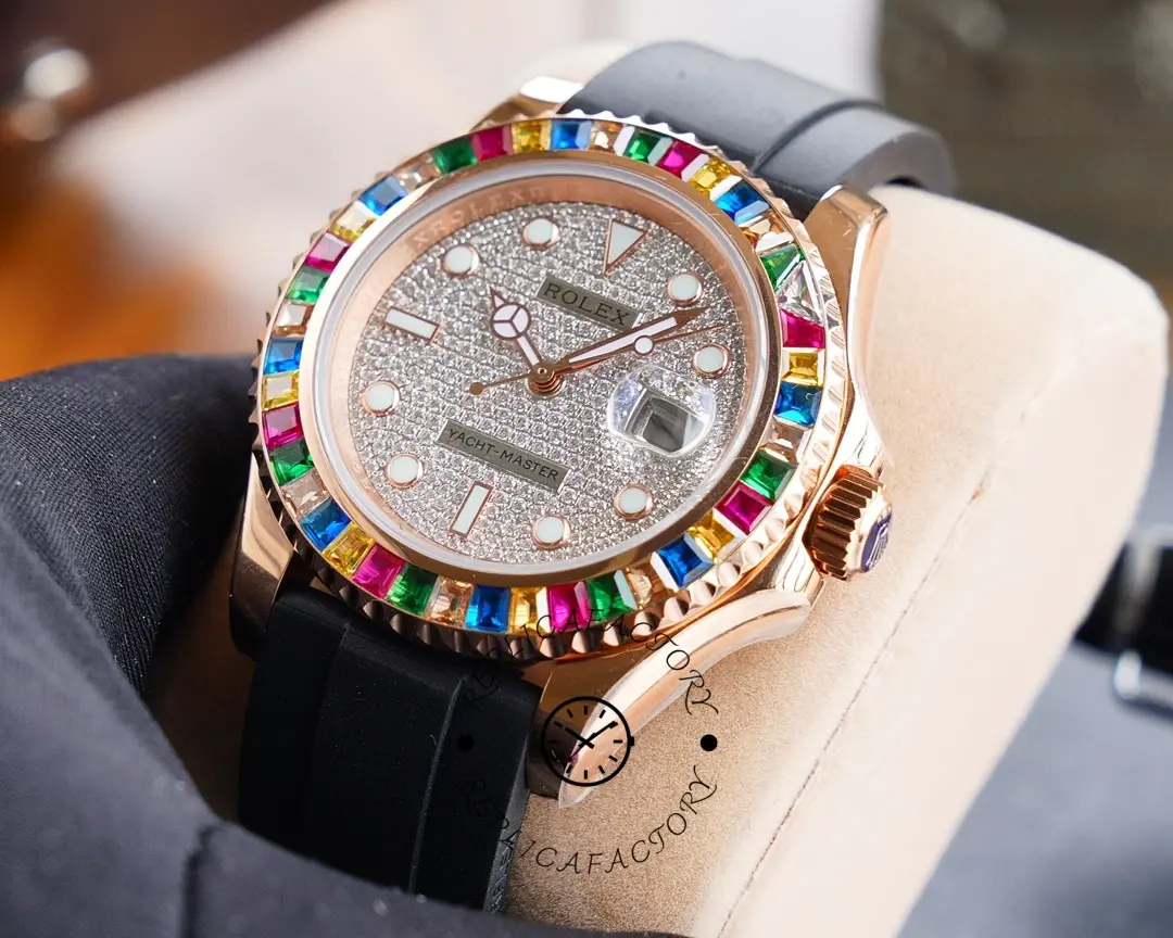 Glove-held close-up of the Rolex Yacht-Master 116695SATS showing dial markers and bezel colors.