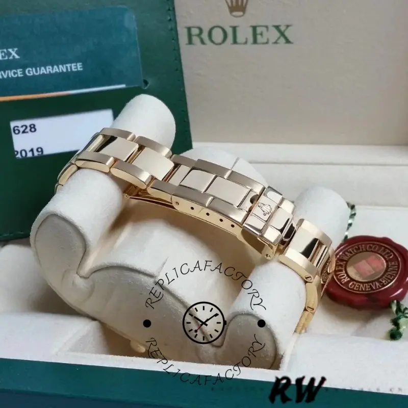 Full set display of the Rolex Yacht-Master 169628 with box and blue dial watch on cushion.