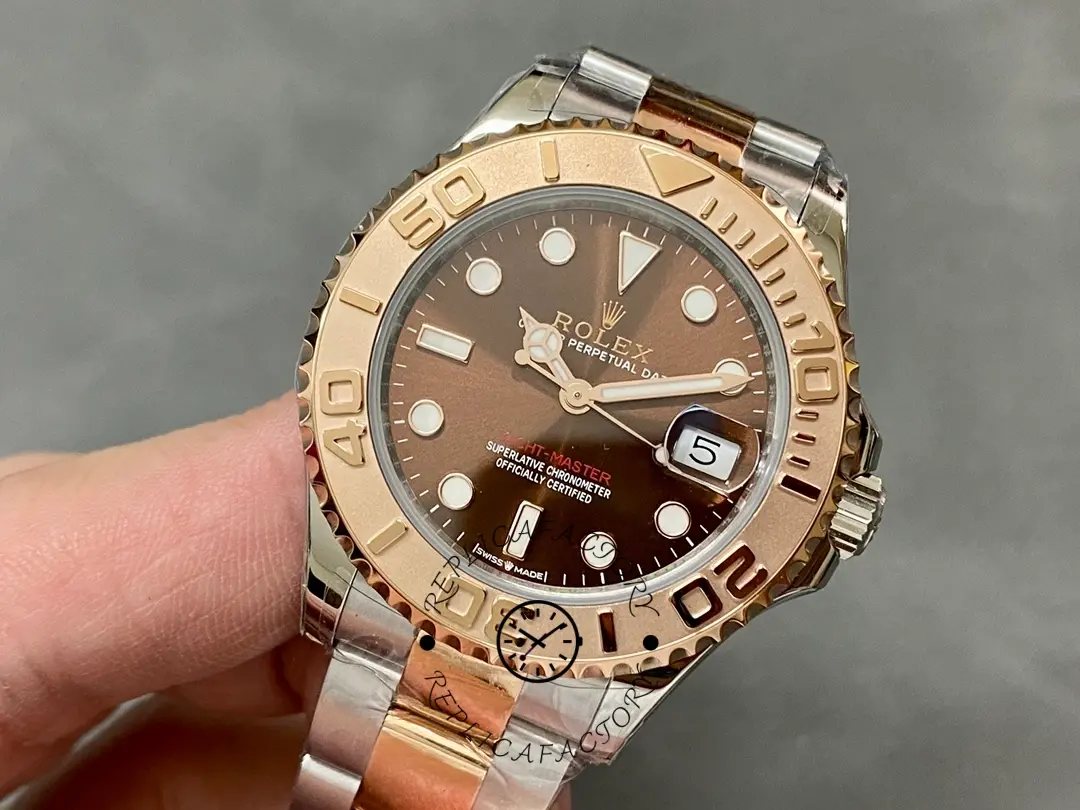 Rolex Yacht-Master 268621 held in hand, angled front view, Everose rolesor bracelet.
