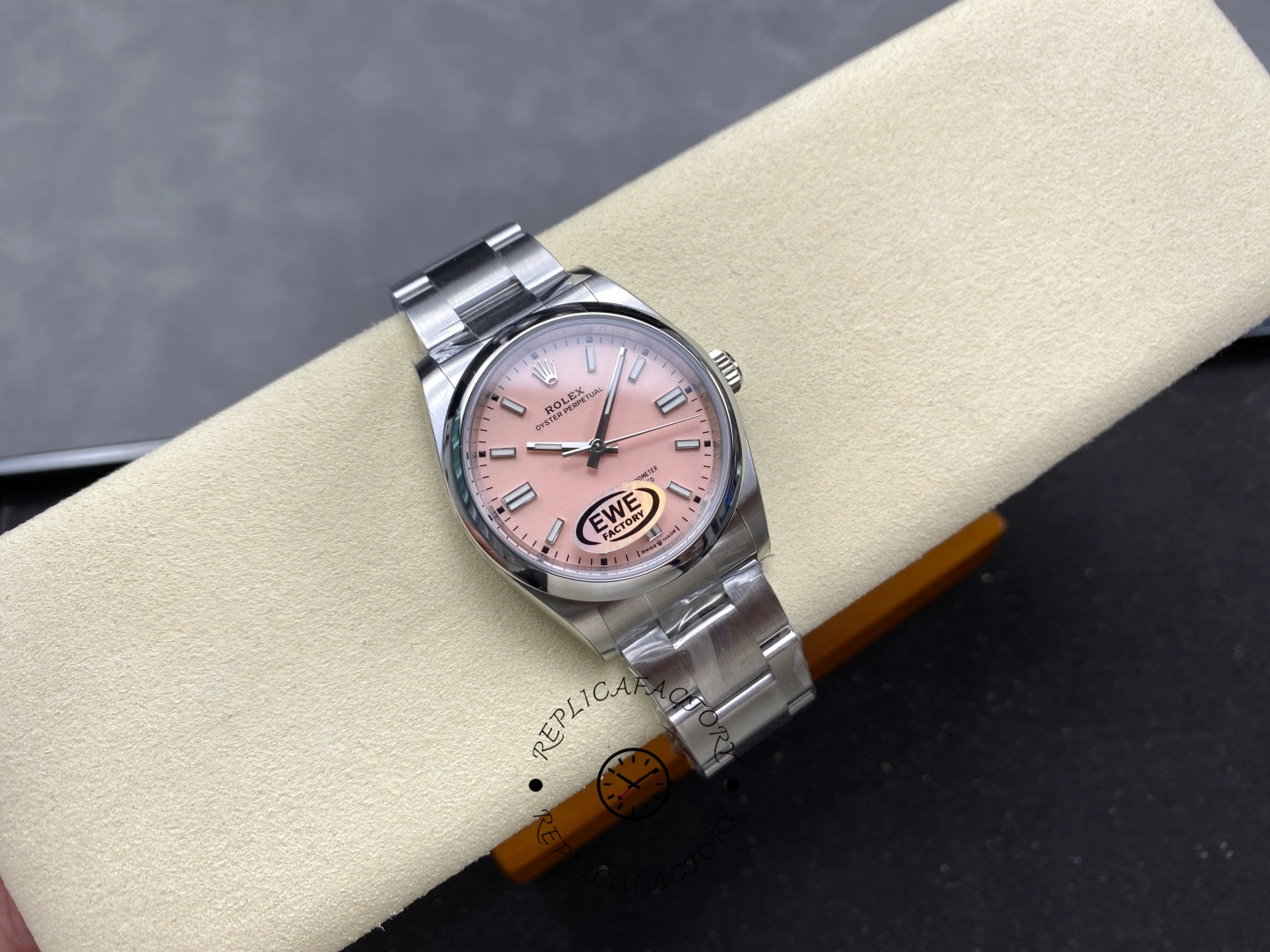 Rolex Oyster Perpetual 31 m277200-0009 on wrist rest, pink dial, Oyster bracelet.