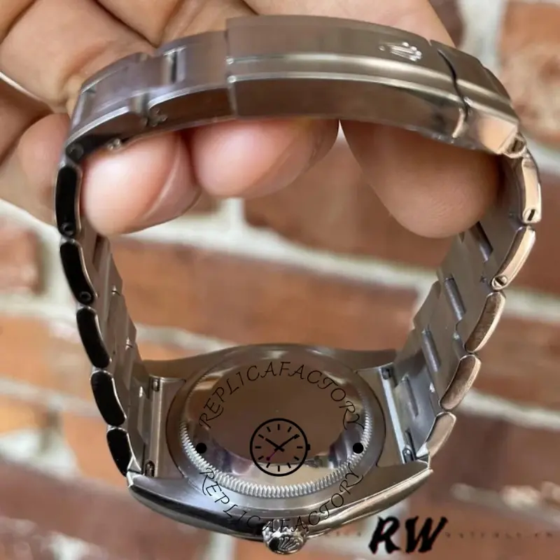 Rolex Oyster Perpetual 116000 case back view, underside and bracelet, held in hand.