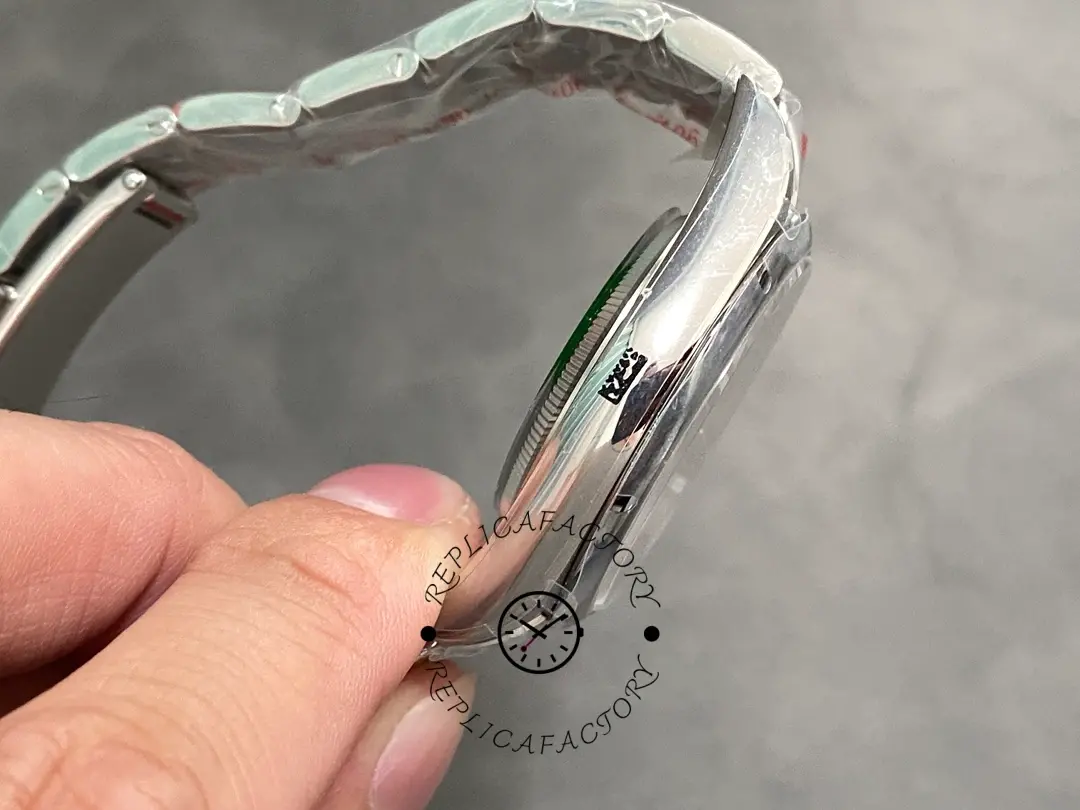 Side view in hand of the Rolex Oyster Perpetual 39 114300 0002 showing case profile and lugs.