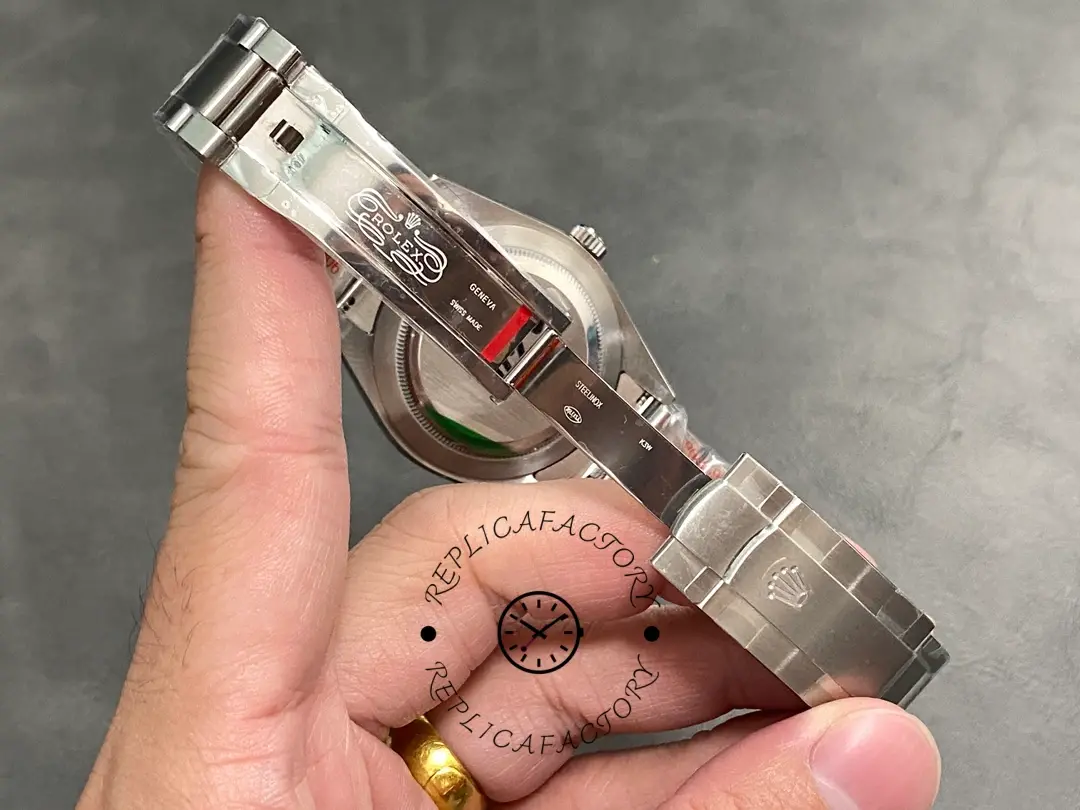 Bracelet and clasp view of the Rolex Oyster Perpetual 39 114300 0002 shown in hand, clasp open.