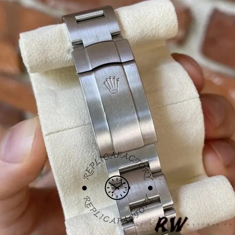 Rolex Oyster Perpetual 116000 bracelet clasp close-up, clasp and links detail, on cushion.