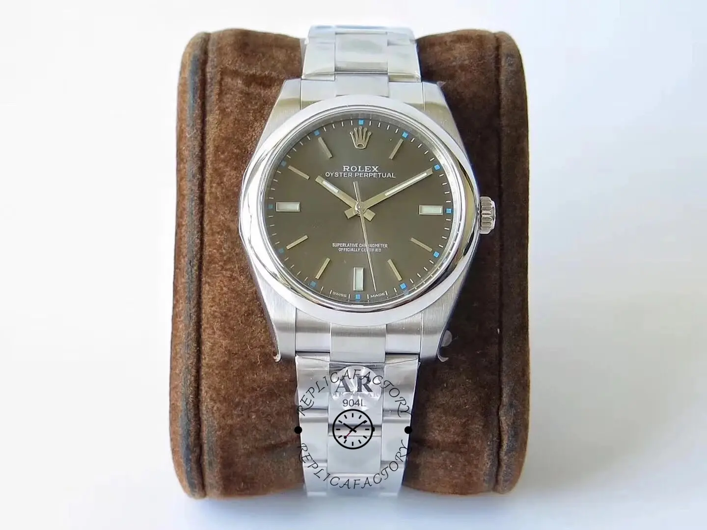 Full watch view of the Rolex Oyster Perpetual 114300 0001 on stand with grey dial visible.