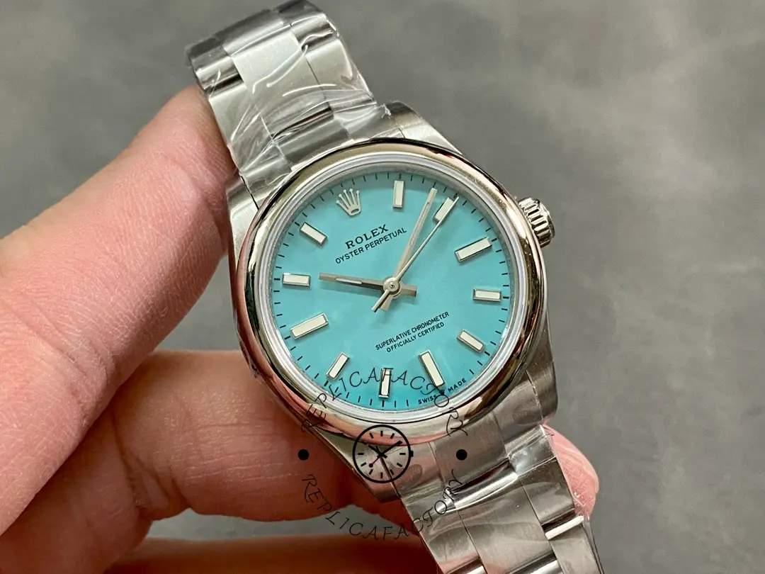 Rolex Oyster Perpetual 31 277200 0007, angled hand-held view showing dial and bracelet links.