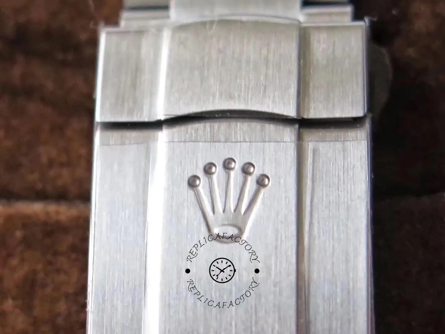 Clasp engraving close-up of the Rolex Oyster Perpetual 114300 0001 showing Rolex coronet.