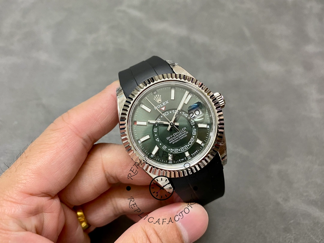 Full watch view in hand of the Rolex Sky-Dweller 336239 showing rubber strap and case.