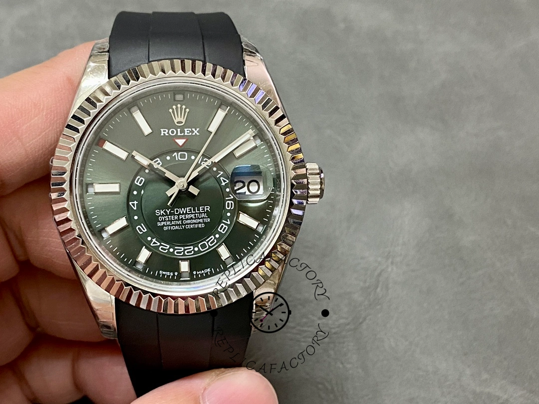 Handheld front view of the Rolex Sky-Dweller 336239 showing green dial and fluted bezel.