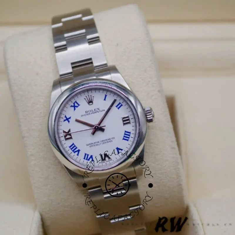 Rolex Oyster Perpetual 177200 on pillow, close front view showing blue Roman numerals on white dial.