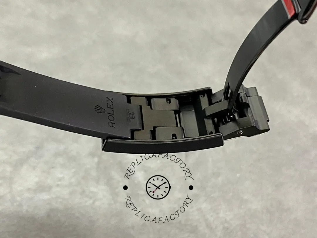 Rolex Blaken Submariner 116610, opened rubber strap showing underside and end.