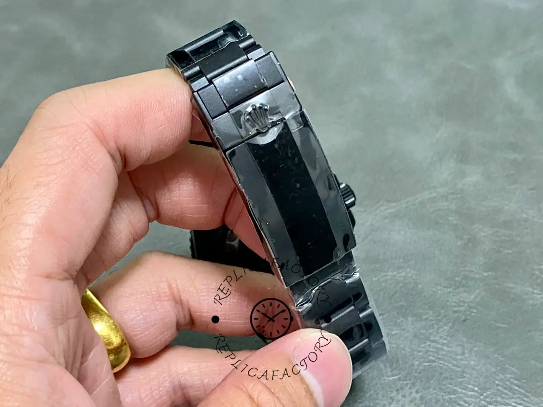 Rolex Submariner 116610, clasp/strap detail shown in hand.
