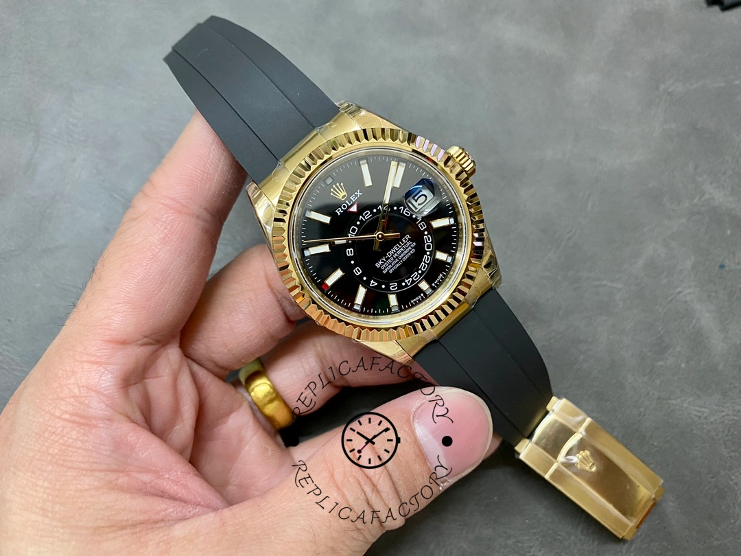 Full watch view in hand of the Rolex Sky-Dweller m336238 0002 showing yellow gold case and strap.