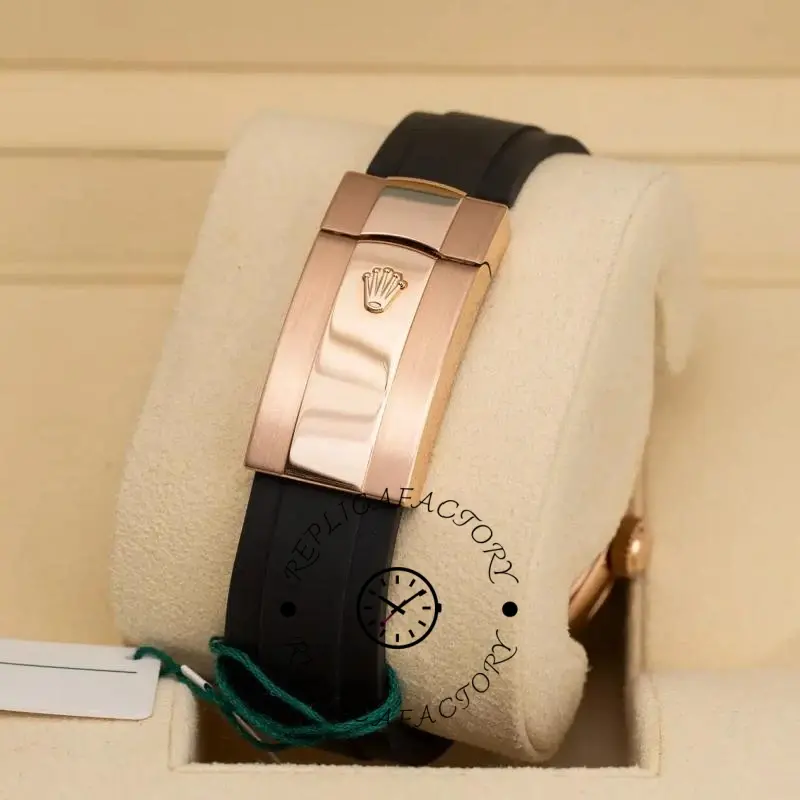 Clasp close-up of Rolex Sky-Dweller m336235 0002, rose gold buckle on black Oysterflex.