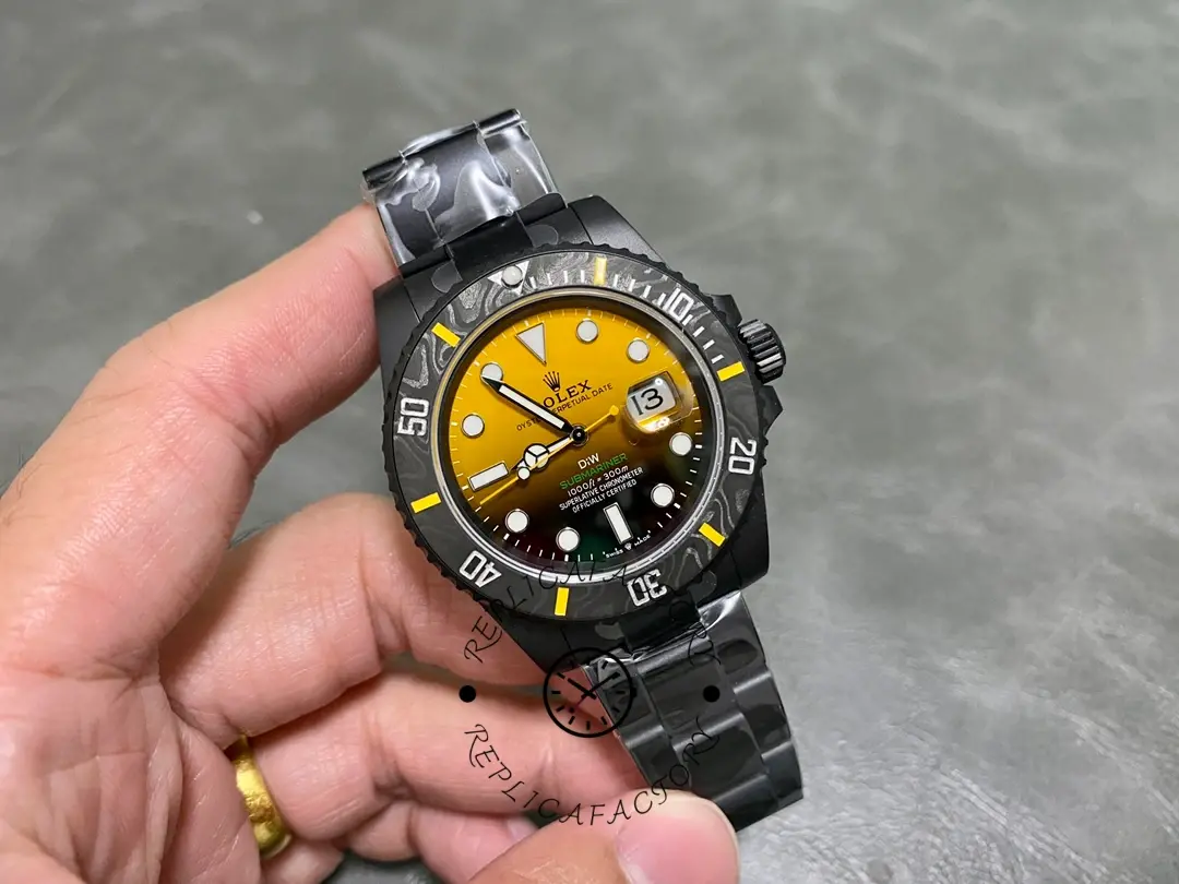 Rolex Submariner 116610, held in hand, full case and strap shown.