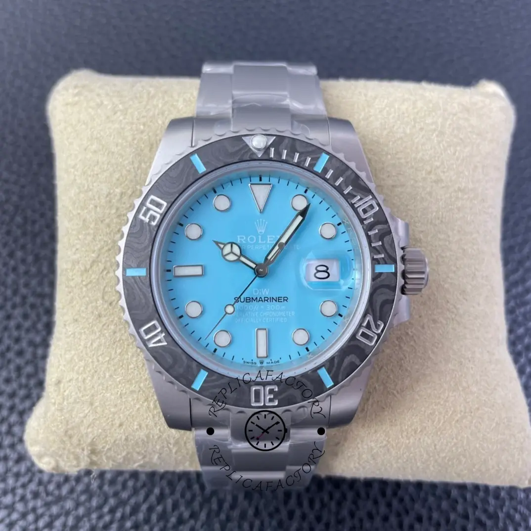 Rolex Submariner DIWF 116610 on pillow, full watch view with ice blue dial and carbon bezel.